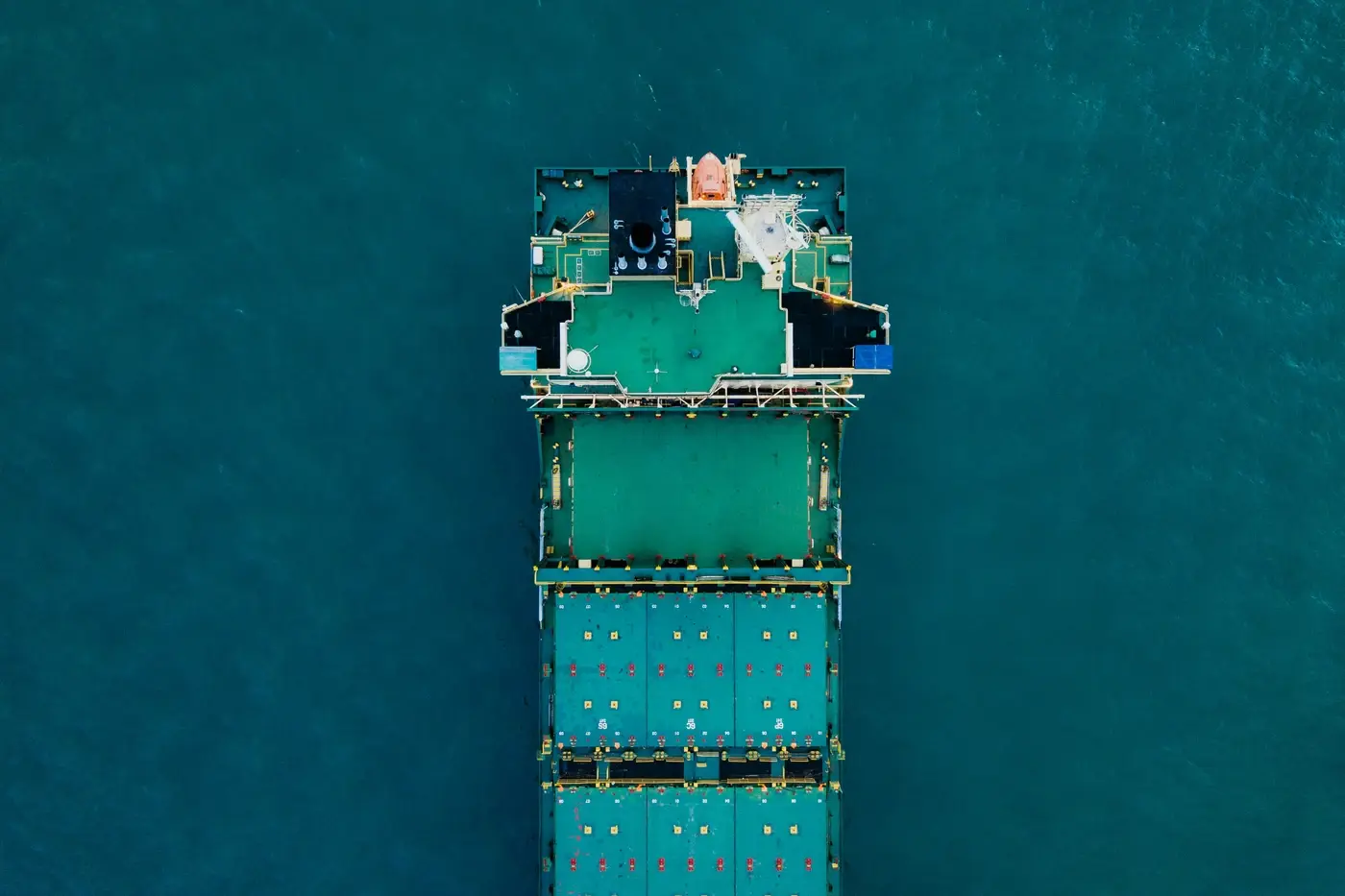 Supply Chain Integration international ship in green that match the ocean floor
