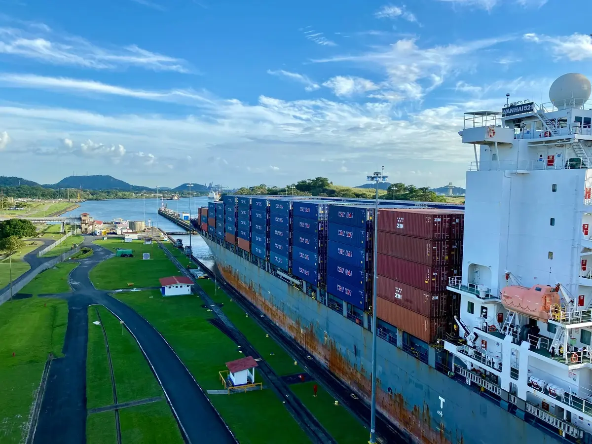 The Panama Canal and supply chain ship on port with a sunny background